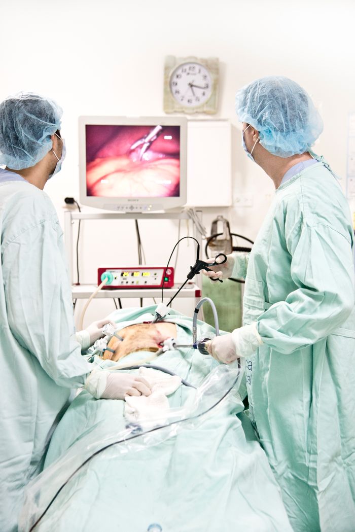 Mastering the First Impression: Your intriguing post title goes here Healthcare professionals performing a laparoscopy in an operating room, showcasing modern medical techniques.